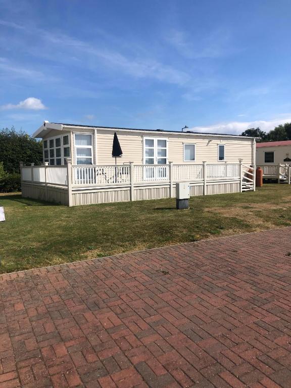 a house with a white fence in front of it at Tide Away Anderby Creek in Anderby