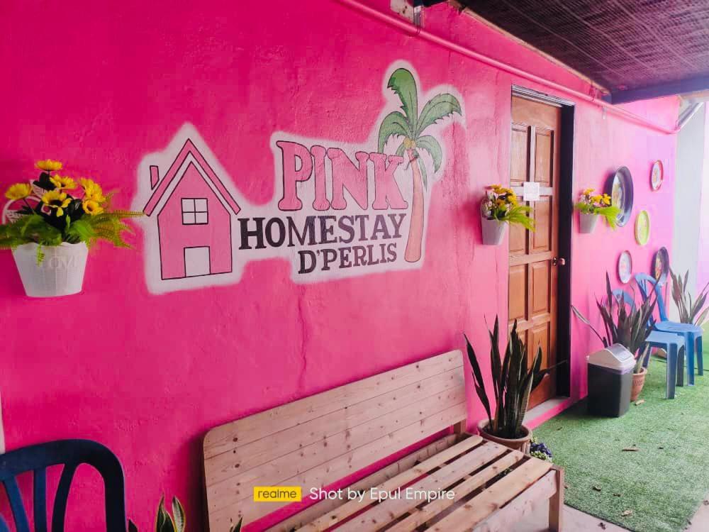 a pink house with a bench in front of it at Pink Homestay D'Perlis in Kangar