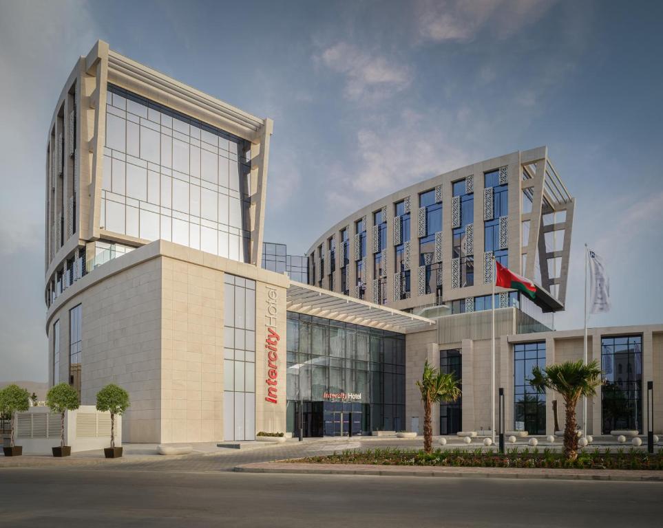 a large building with a plane on the side of it at IntercityHotel Muscat in Muscat