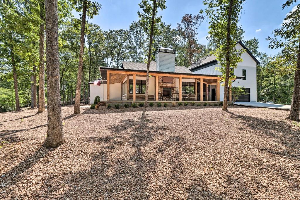 a house in the woods with a large yard at All-Encompassing Lakehouse with Modern Accents! in Fairfield Bay