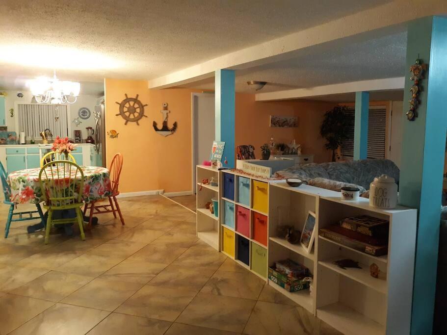 a room with a kitchen and a dining room with a table at Nana's Cheerful cottage in Melbourne