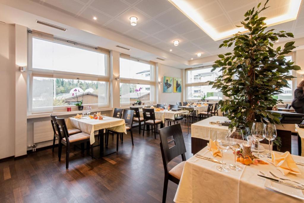 um restaurante com mesas e cadeiras e uma árvore de Natal em Hotel Thorenberg em Lucerna