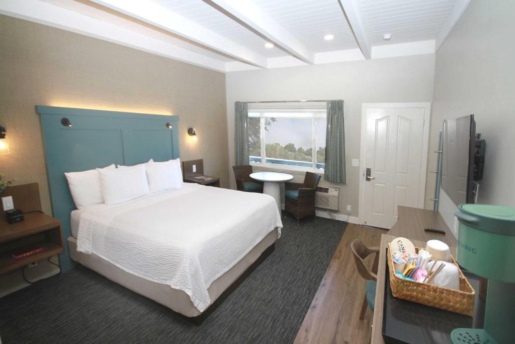 a bedroom with a white bed and a window at Castle Inn in Cambria