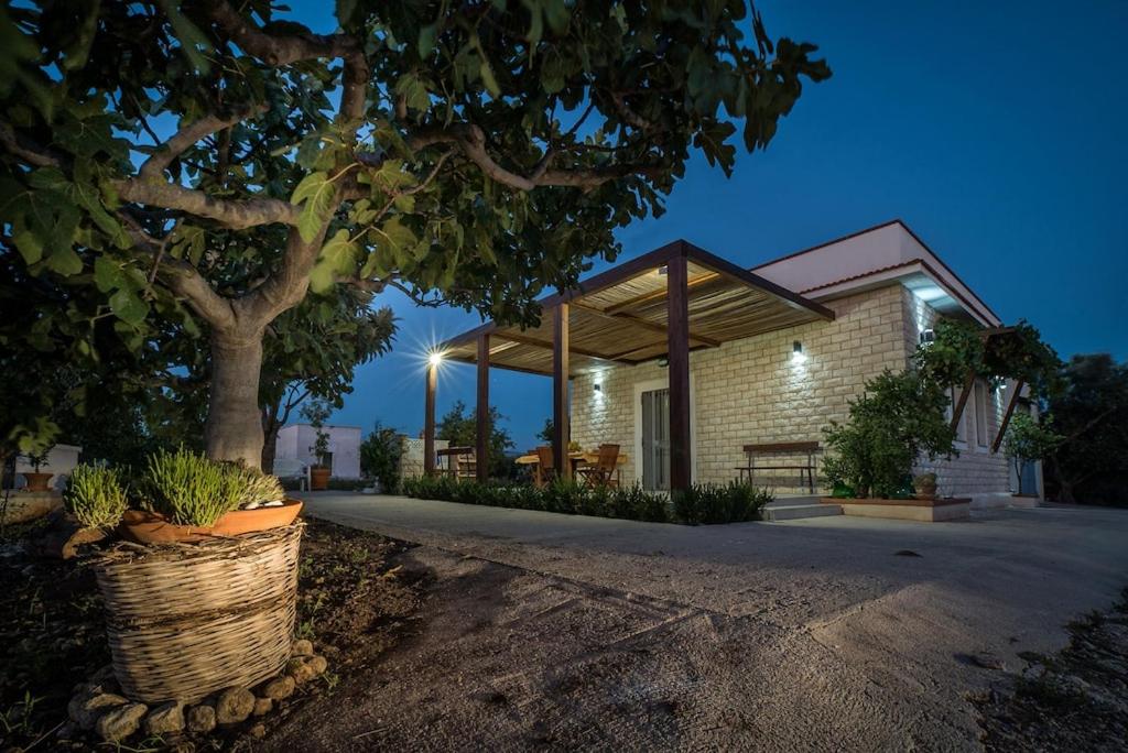 a house with a tree in front of it at Casa vacanze "Ulivi nel Mare" in Sciacca