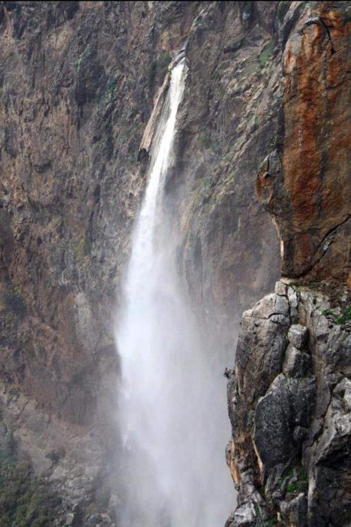 a waterfall on the side of a mountain at Wooden House at the Mountain-private in Paránimfoi