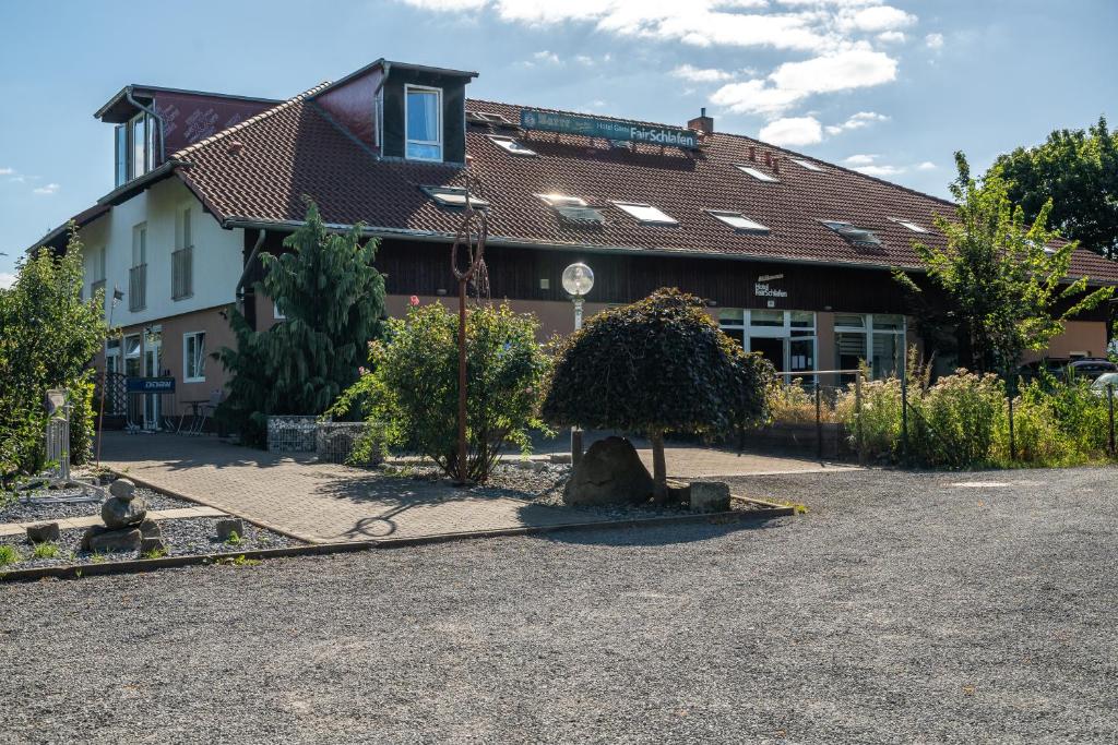 a building with a tree in the middle of a driveway at Hotel Garni FairSchlafen in Minden