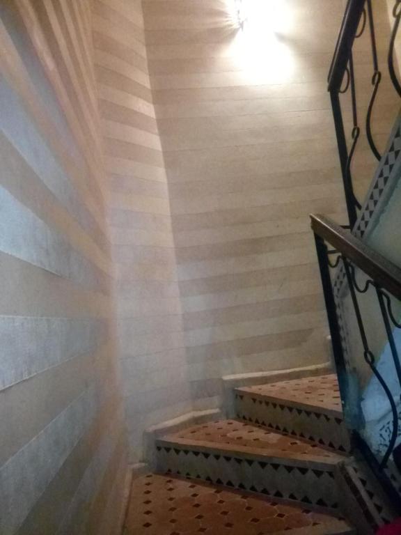 a set of stairs in a room with wooden walls at guest house le petit jardin 2 in Marrakech