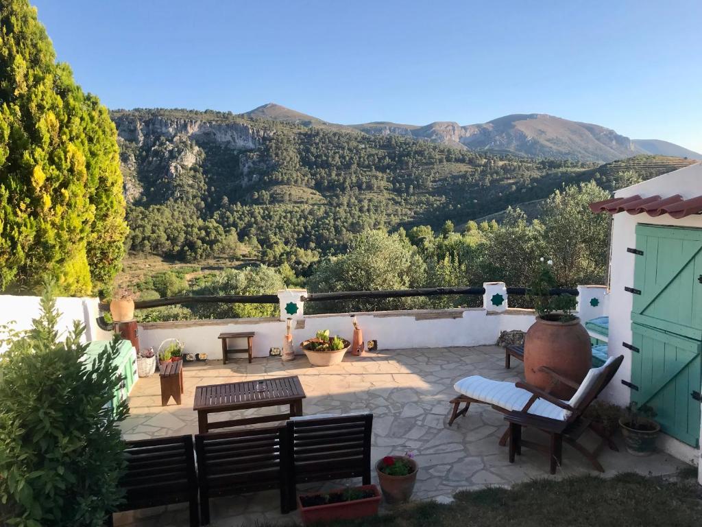 eine Terrasse mit Bänken und Bergblick in der Unterkunft al-qandil in Margarida