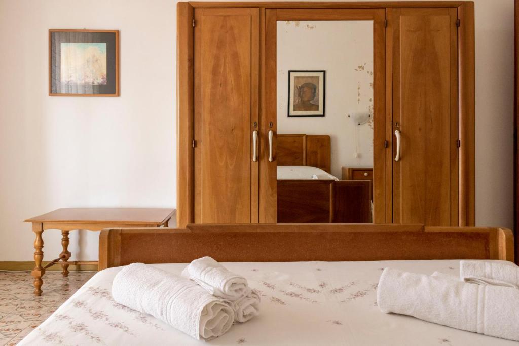 a bedroom with a bed and a large mirror at Casa Raffaela in Modica