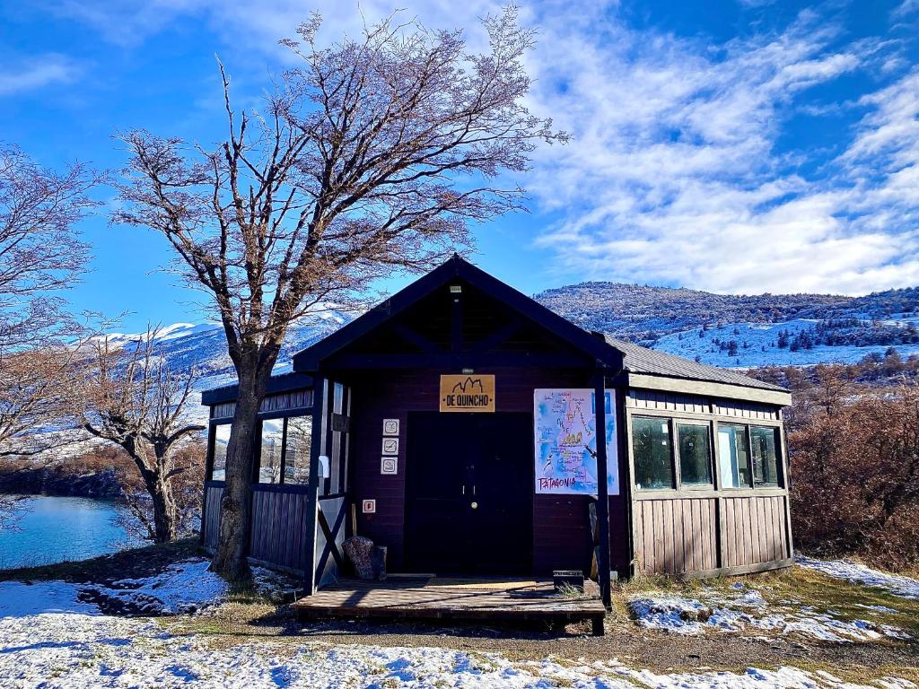 a small building with a sign on the door at CAMPING KAU LAGUNA AZUL in Torres del Paine
