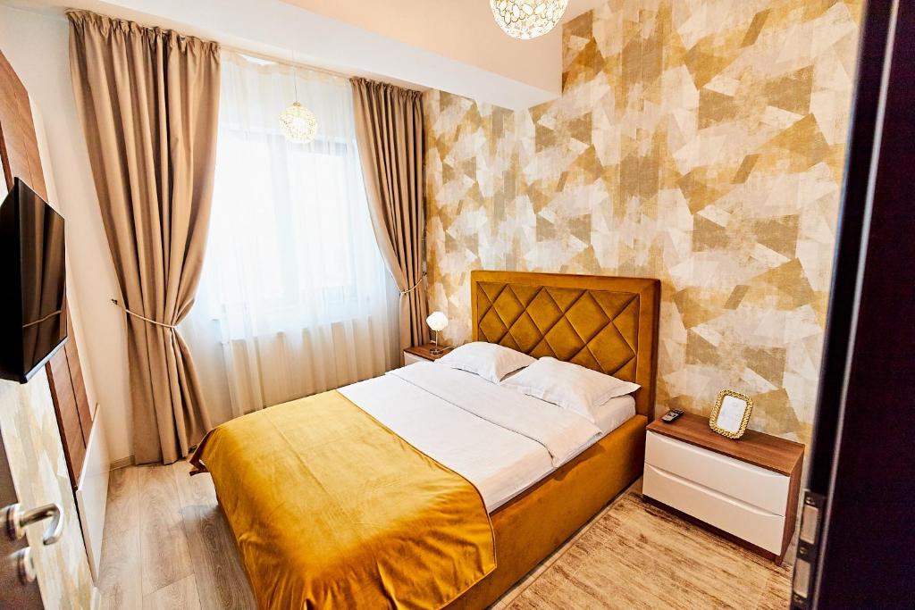 a bedroom with a bed and a window at CityLife Apartments in Iaşi