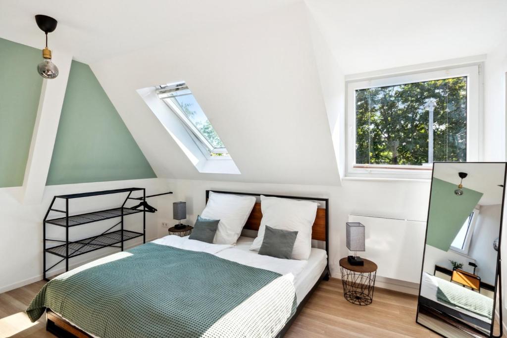 a bedroom with a bed and a window at Your home away from home - A workplace in every room in Hannover