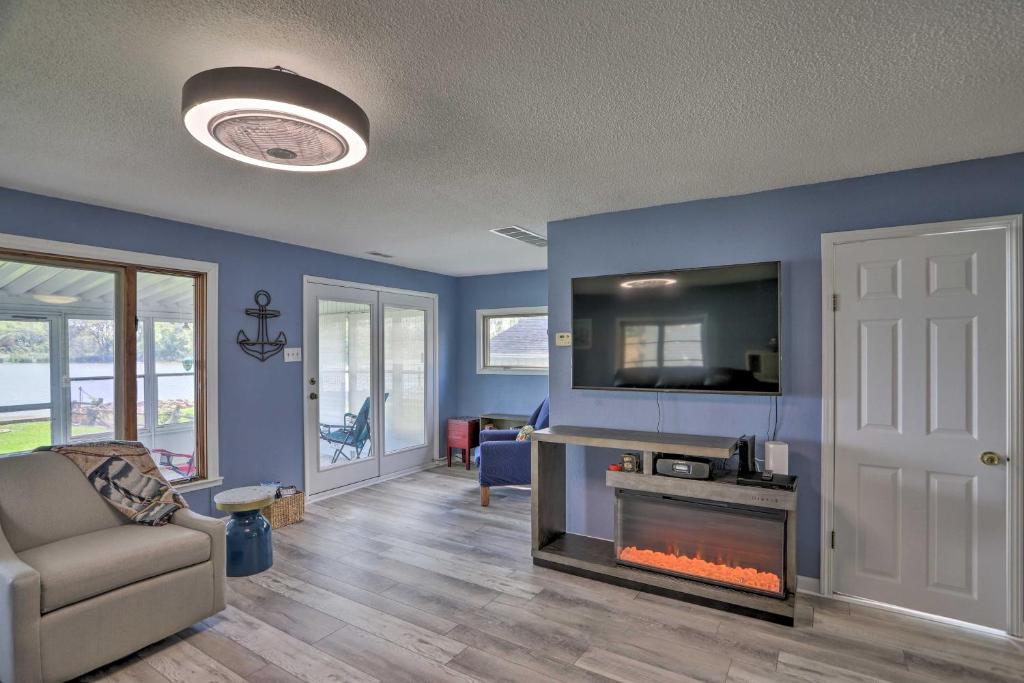 a living room with a couch and a fireplace at Lake Erie Waterfront Home with Sunroom and Yard! in Erie