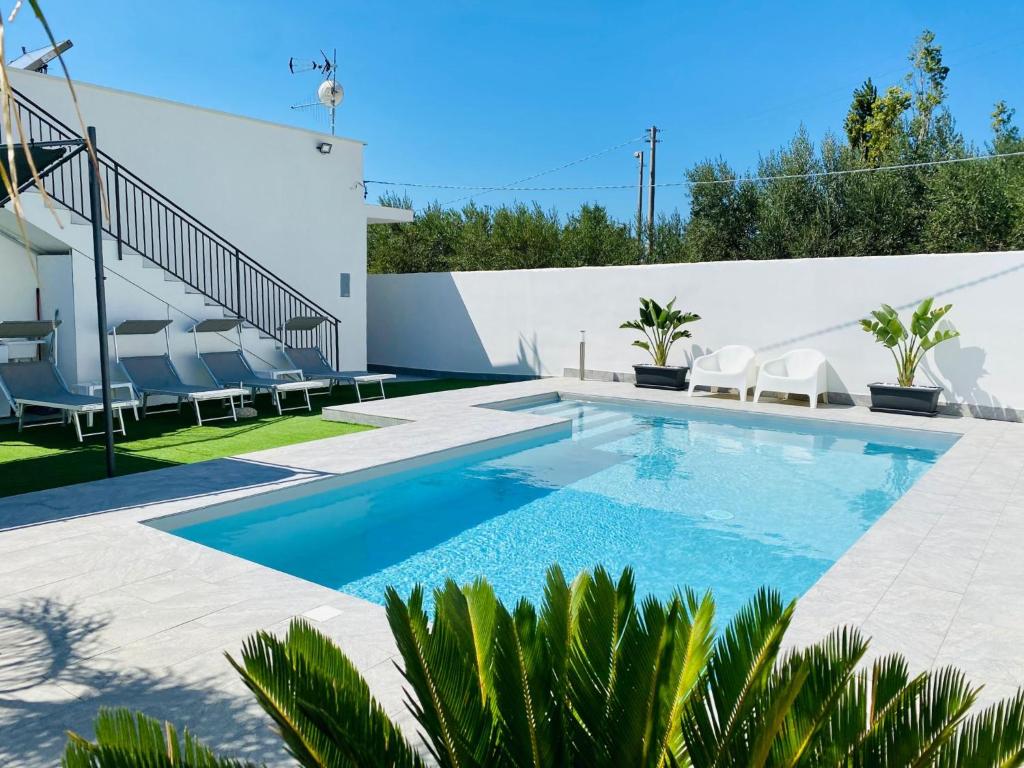 a swimming pool in the backyard of a house at Katy's Holiday House, Private Villa in Terrasini
