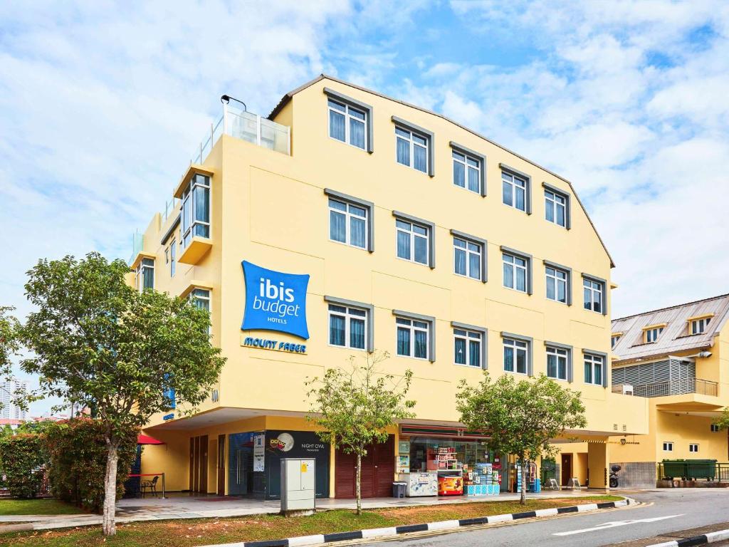 a yellow building with a big sign on it at ibis budget Singapore Mount Faber in Singapore