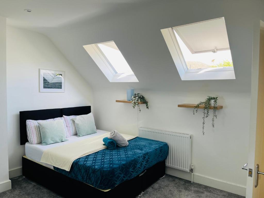 a bedroom with a bed with two skylights at Castle view Rochester in Rochester