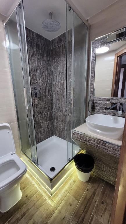 a bathroom with a shower and a sink and a toilet at 72 Tottenham Court Road in London