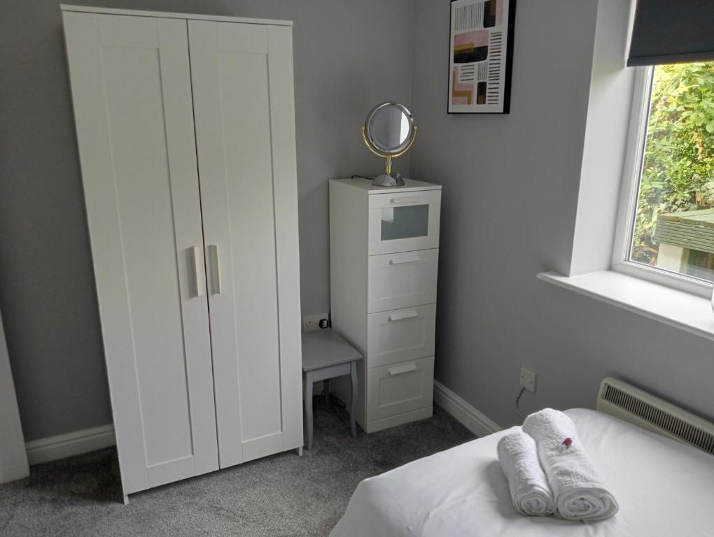 a bedroom with a white cabinet and a bed at Green Street Retreat in York