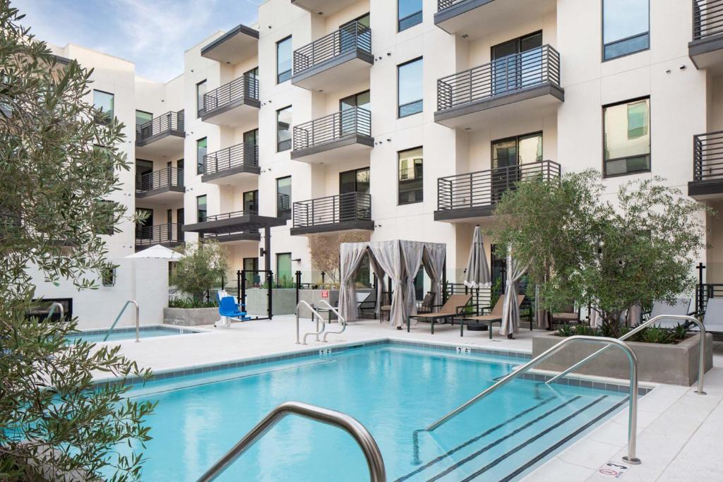 an image of a swimming pool in front of a building at Sentral Old Town in Scottsdale