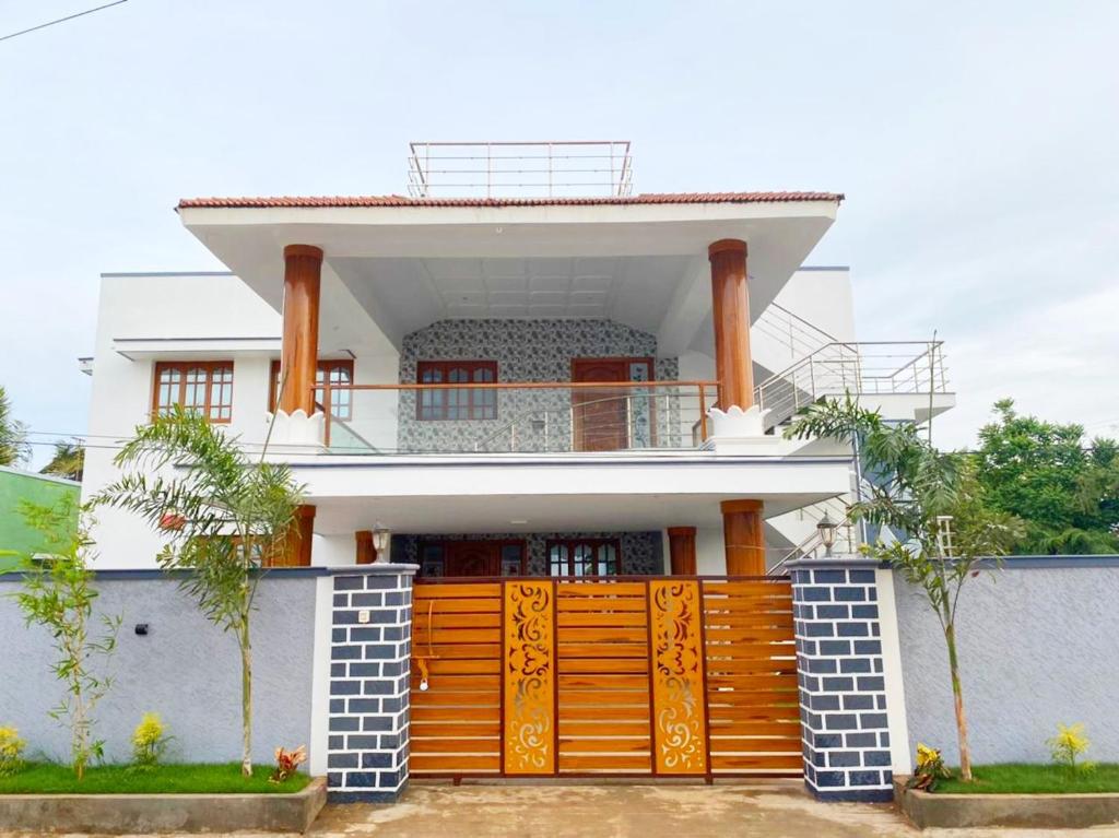 a house with a gate in front of it at Coimbatore Premium Private Villa a FAMILY RESORT kids, celebration hall in Coimbatore