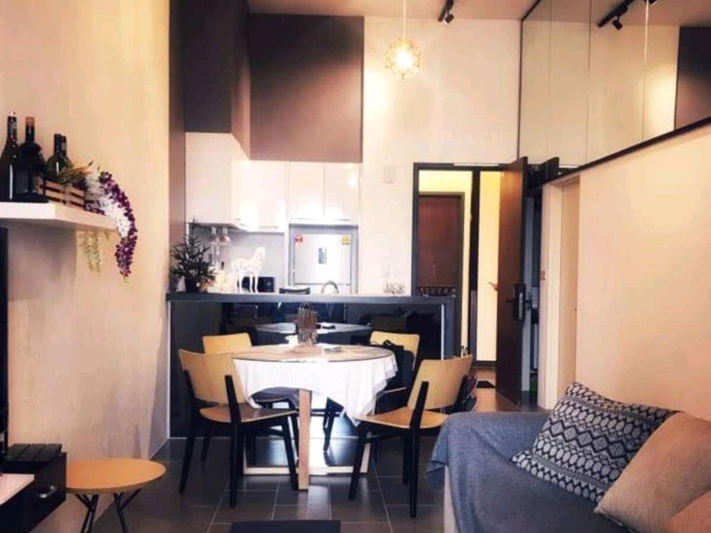 uma cozinha e uma sala de jantar com mesa e cadeiras em Charming Bedroom - next to train station at Est Bangsar em Kuala Lumpur