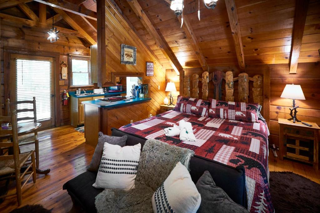 a bedroom with a bed in a log cabin at Gatlinburg Area Hottub Cabin - Ladyslipper in Sevierville