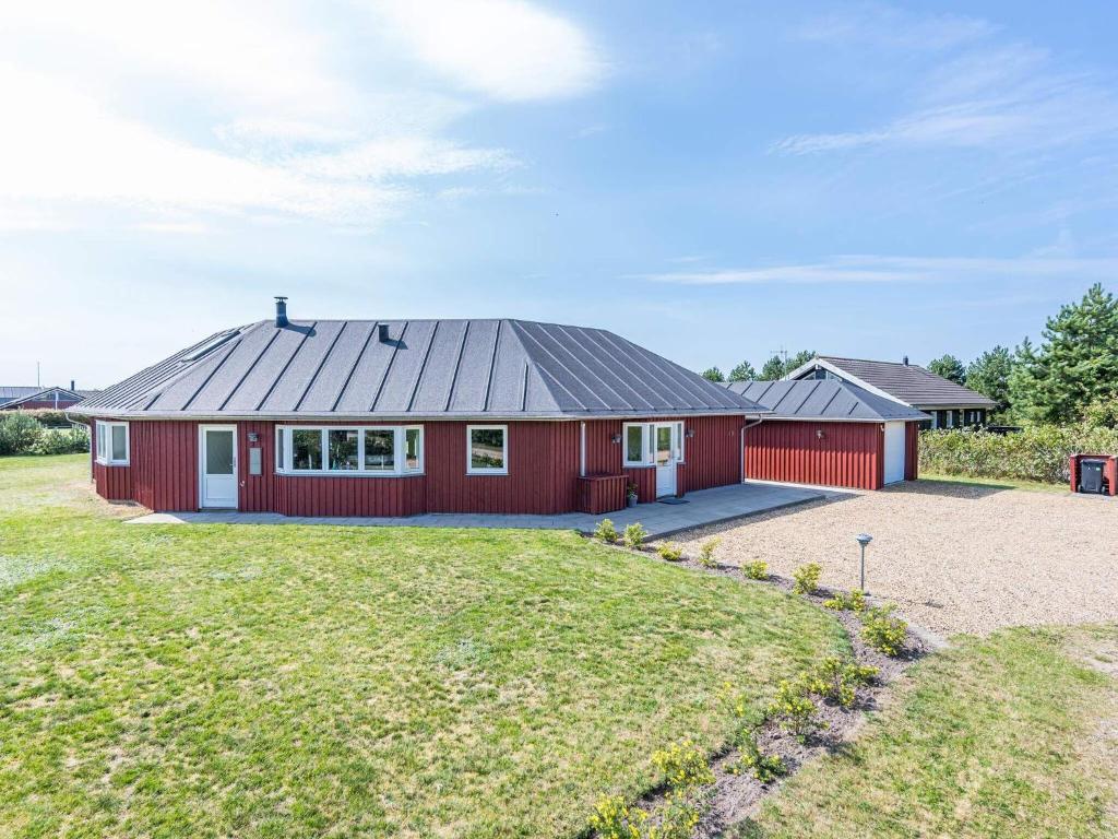 a red house with a large yard at 8 person holiday home in Tarm in Tarm