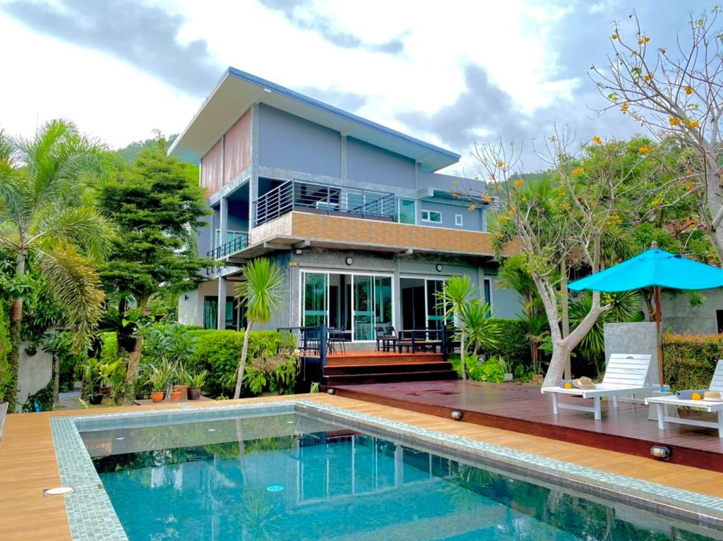 a house with a swimming pool in front of a house at Siya Private Pool Villa Ao Nang in Ao Nang Beach