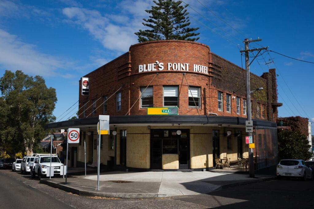 a brick building with a sign that reads blues point home at Blues Point Hotel in Sydney