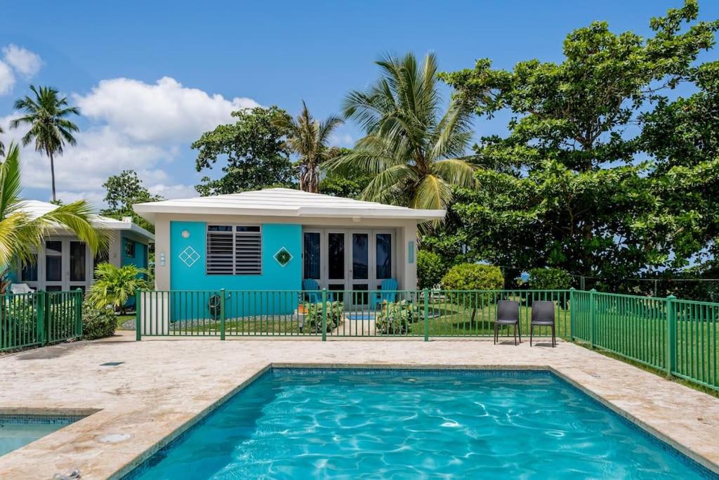 a house with a swimming pool in front of a house at Beautiful Ocean Front Villa in Aguada