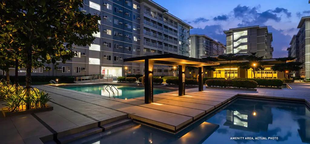 una piscina con cenador junto a un edificio en Whole Condo with Pool Great for Staycation en Manila