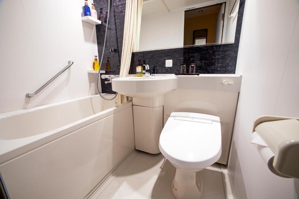 a bathroom with a white toilet and a sink at Rinn Gion Kenninji in Kyoto