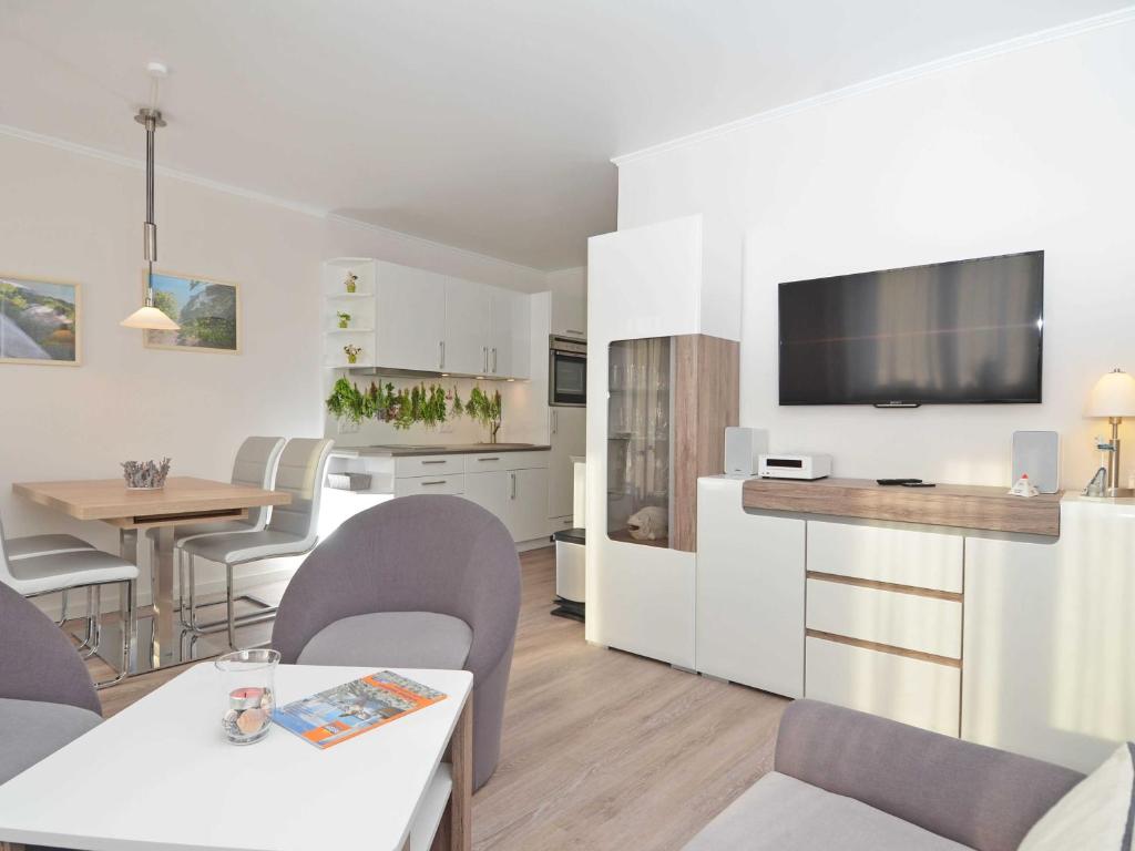 a living room with a kitchen and a dining room at Wohnpark Stadt Hamburg - Apt. 09 in Binz