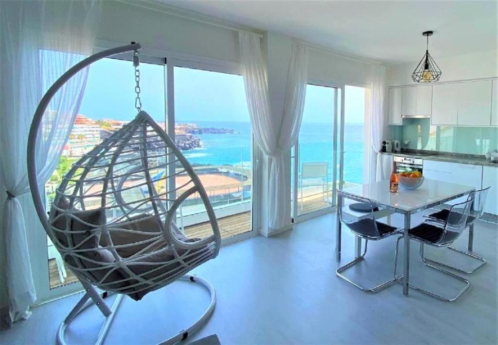 a kitchen with a swing in front of a large window at PaulMarie Gigantes Fantastic View in Puerto de Santiago