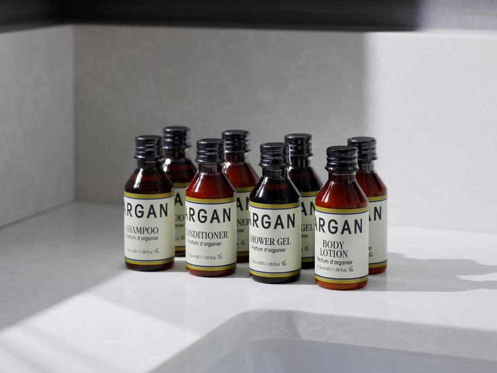 a group of bottles of beer sitting on a counter at THE HOTEL SANRAKU KANAZAWA 21th December 2022 OPEN in Kanazawa