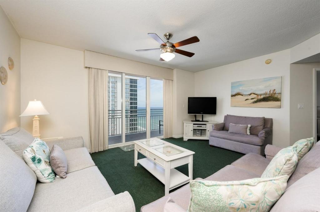 a living room with a couch and a tv at Unit 2430 Ocean Walk - 2 Bedroom Ocean View in Daytona Beach