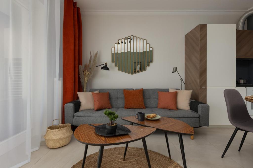a living room with a couch and a table at Lakeview Apartment Kapelanów Armii Krajowej by Renters in Warsaw