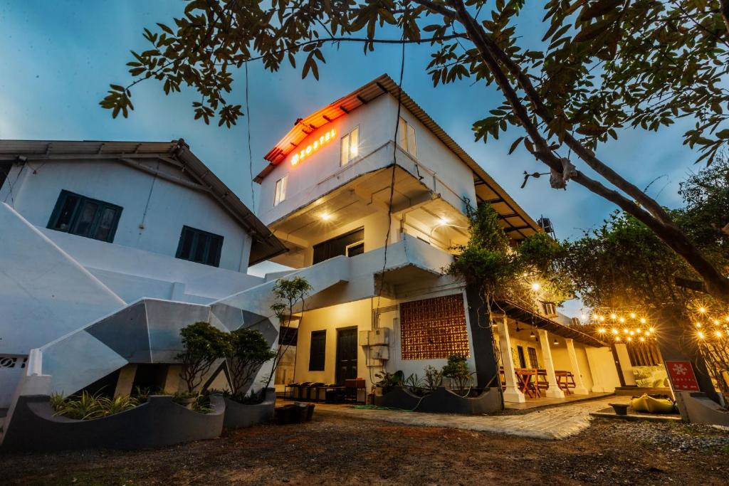 a house with lights on the side of it at Zostel Alleppey in Alleppey