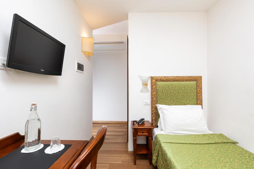 Postel nebo postele na pokoji v ubytování Hotel Giardinetto Venezia