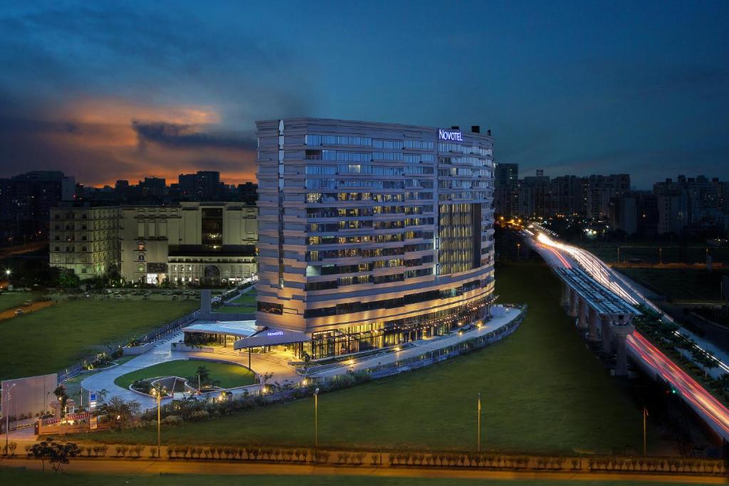 a tall building in a city at night at Novotel Kolkata Hotel and Residences in Kolkata