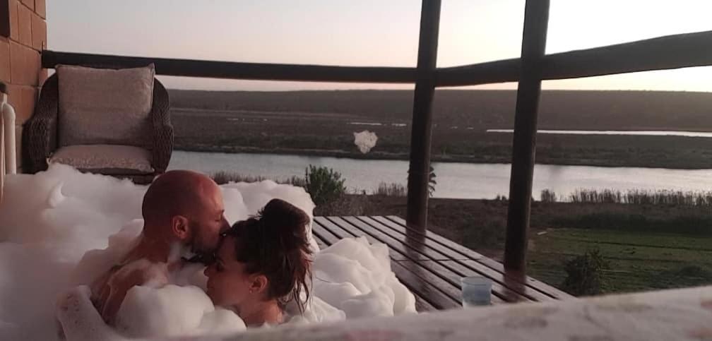 a bride and groom in a bathtub covered in snow at The love bubble in Lutzville