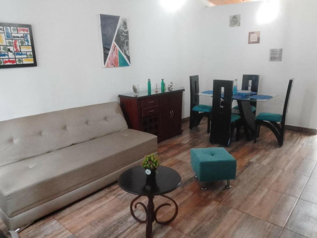 a living room with a couch and a table at Casa acogedora en Santa Rosa de Cabal in Santa Rosa de Cabal