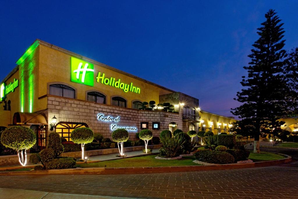 a hollywood inn building with a lit up sign at Holiday Inn Queretaro Centro Historico, an IHG Hotel in Querétaro