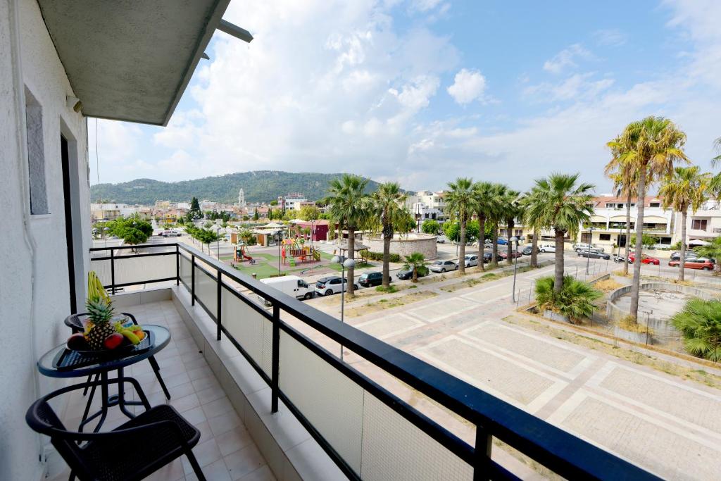 a balcony with a table and a view of a city at Palm Square Appart in Ialysos
