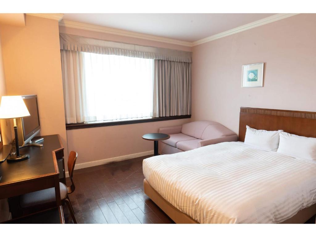 Postel nebo postele na pokoji v ubytování Hotel Castle Inn Tsu