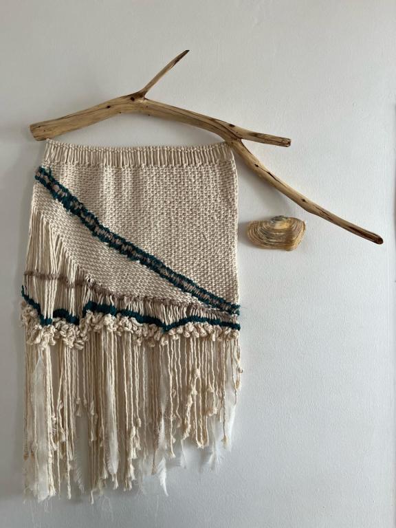 a beaded fringe item hanging on a wall at Fisherman´s Cave in Faro