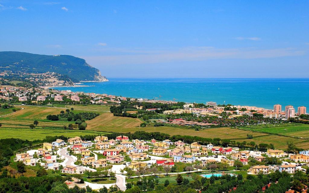 a large city with a beach and mountains at Adamo Ed Eva Resort in Numana