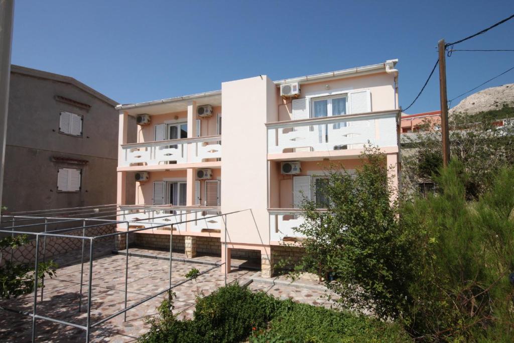 a white building with stairs in front of it at Rooms by the sea Metajna, Pag - 6378 in Metajna