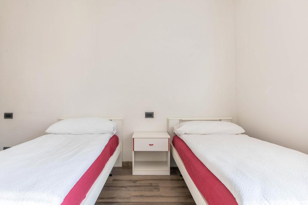 Łóżko lub łóżka w pokoju w obiekcie Appartamento dorsino