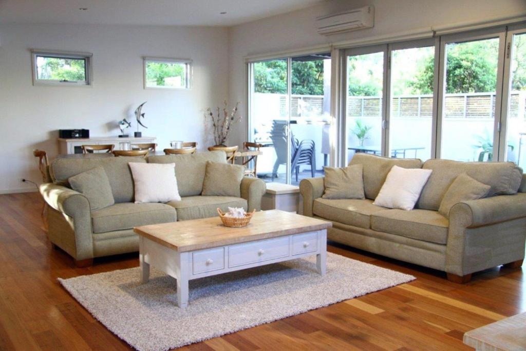 a living room with two couches and a coffee table at La mer - Pet Friendly in Inverloch